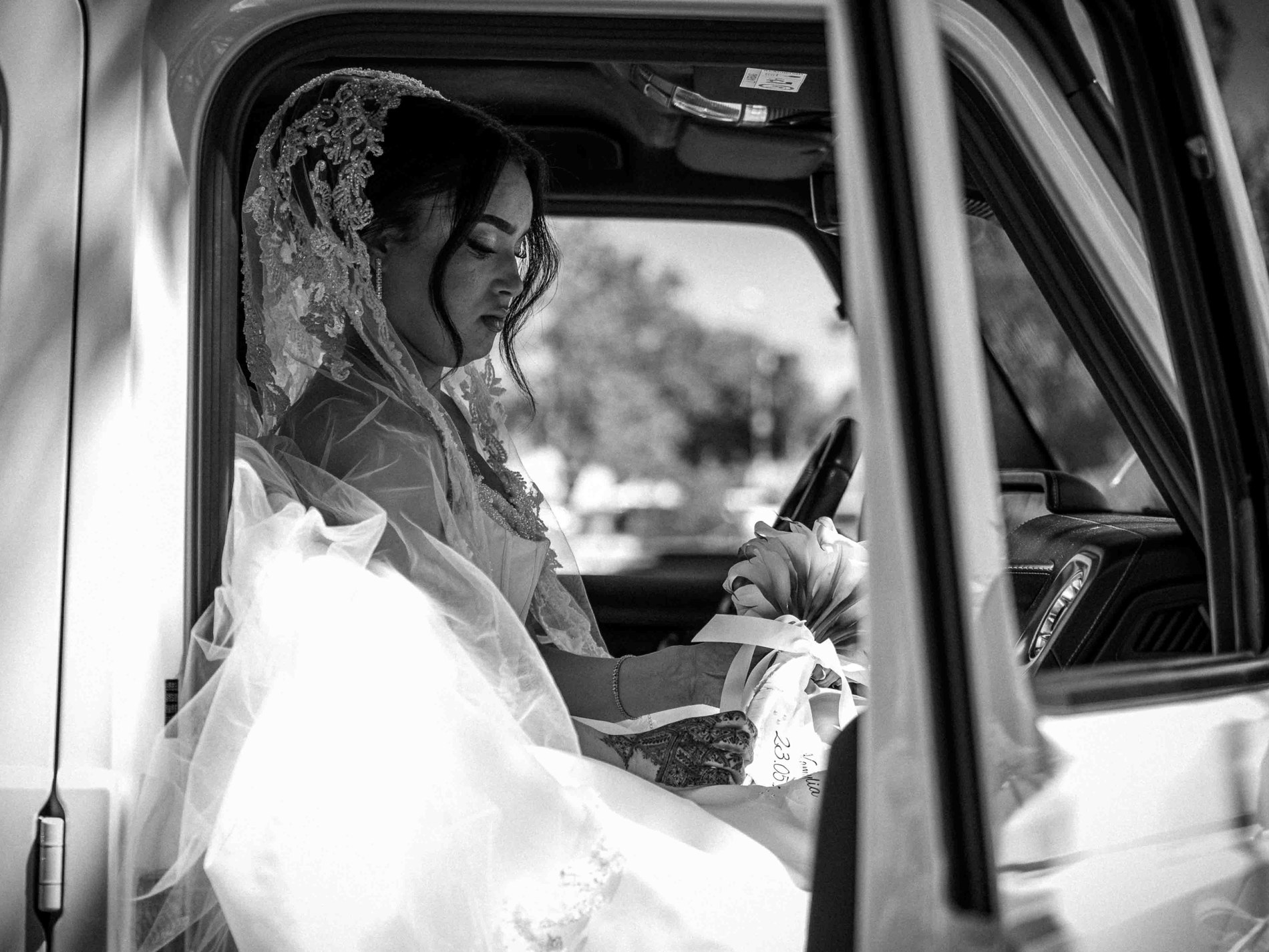 La mariée dans la voiture, bouquet à la main